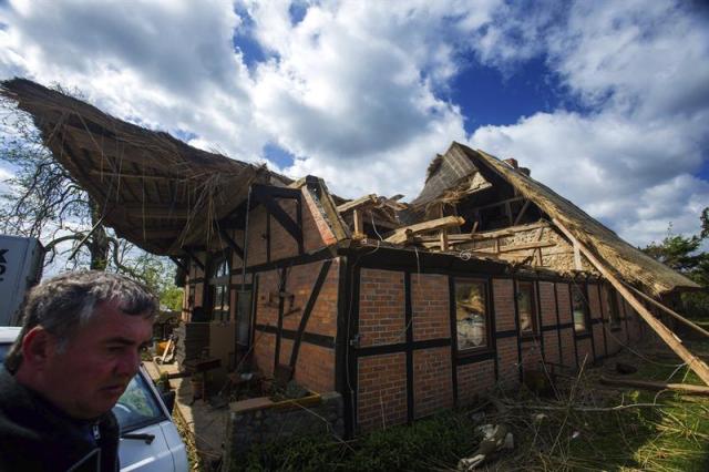 Fred Götze (izq) junto a su casa hoy, jueves 7 de mayo de 2015, dos días después del paso de un tornado por Bützow, norte de Alemania. El tornado ha causado cuantiosos daños materiales, además de treinta heridos leves y uno grave, según el balance facilitado ayer por las autoridades municipales. EFE/Jens Buettner