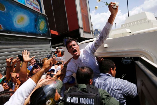 Venezuelan opposition leader Leopoldo Lopez gets into a National Guard armored vehicle in Caracas