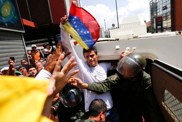 Venezuelan opposition leader Leopoldo Lopez gets into a National Guard armored vehicle in Caracas