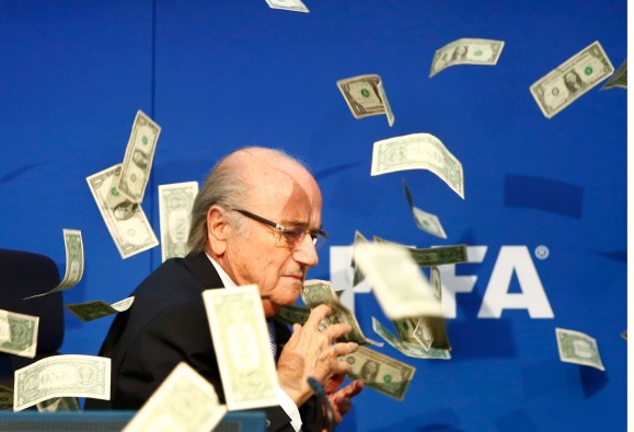 Banknotes are thrown at FIFA President Blatter as he arrives for a news conference after the Extraordinary FIFA Executive Committee Meeting at the FIFA headquarters in Zurich