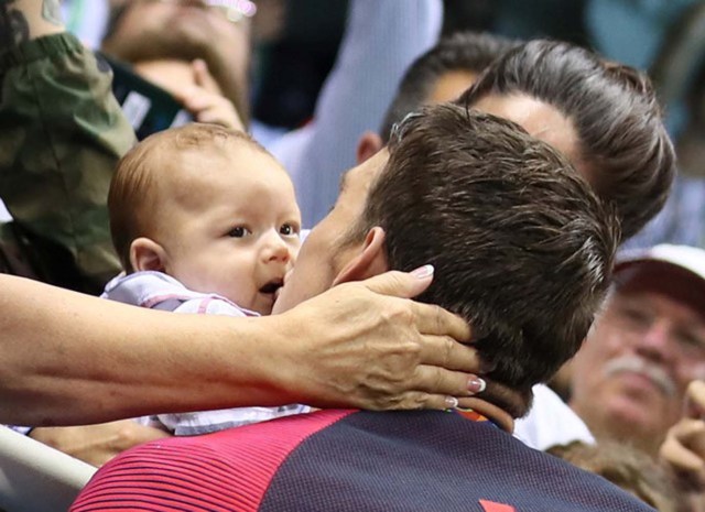 2016 Rio Olympics - Swimming - Victory Ceremony - Men's 200m Butterfly Victory Ceremony - Olympic Aquatics Stadium - Rio de Janeiro, Brazil - 09/08/2016. Michael Phelps (USA) of USA greets his son Boomer after he won the gold medal.    REUTERS/Stefan Wermuth  FOR EDITORIAL USE ONLY. NOT FOR SALE FOR MARKETING OR ADVERTISING CAMPAIGNS.