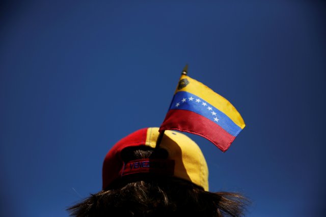 A protester carries a Venezuelan flag on her cap during a demonstration to demand a referendum to remove Venezuela's President Nicolas Maduro, in Madrid, Spain, September 4, 2016. REUTERS/Susana Vera