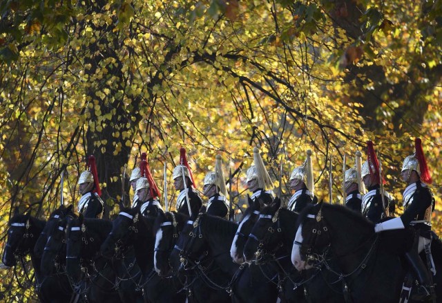 Members of the Household Cavalry ride out amongst autumn foliage early morning in Hyde Park in London in Britain, November 2, 2016. REUTERS/Toby Melville
