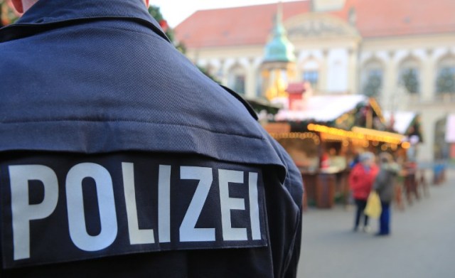 Policemen patrol over a Christmas market in Magdeburg, eastern Germany, on December 20, 2016, as security measures are taken after a deadly rampage by a lorry driver at a Berlin Christmas market. German Chancellor Angela Merkel said that authorities believe the rampage, killing 12, was a "terrorist" attack likely committed by an asylum seeker. / AFP PHOTO / dpa / Peter Gercke / Germany OUT