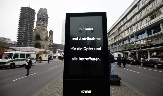 A sign reading 'In sorrow and sympathy for the victims and all concerned' is seen in front of the Christmas market near the Kaiser-Wilhelm-Gedaechtniskirche (Kaiser Wilhelm Memorial Church), the day after a terror attack, in central Berlin, on December 20, 2016. German police said they were treating as "a probable terrorist attack" the killing of 12 people when the speeding lorry cut a bloody swath through the packed Berlin Christmas market. / AFP PHOTO / Tobias SCHWARZ