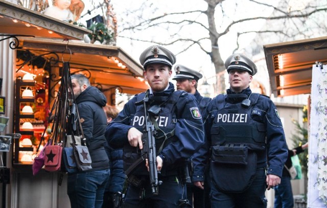 Policemen patrol over a Christmas market in Duesseldorf, western Germany, on December 20, 2016, as security measures are taken after a deadly rampage by a lorry driver at a Berlin Christmas market. German Chancellor Angela Merkel said that authorities believe the rampage, killing 12, was a "terrorist" attack likely committed by an asylum seeker. / AFP PHOTO / dpa / Federico Gambarini / Germany OUT