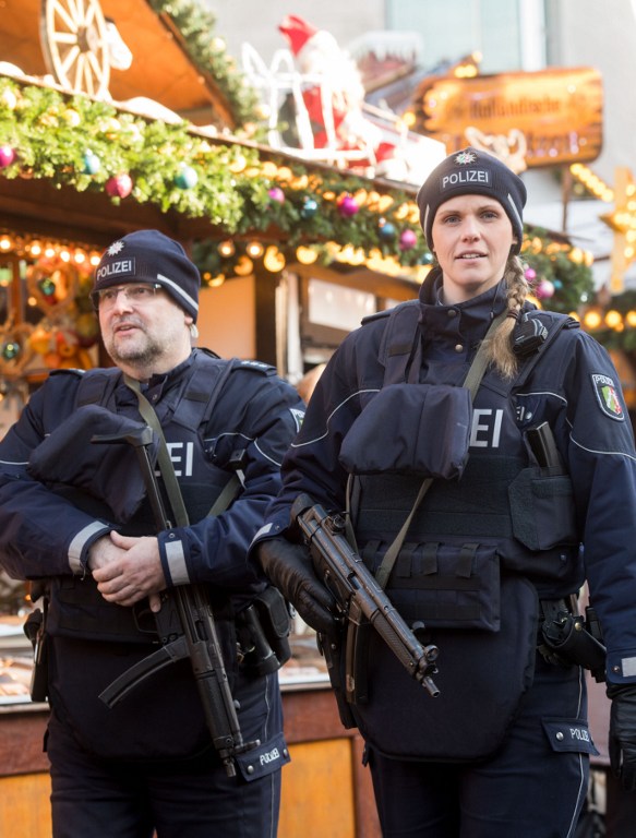 Policemen patrol over a Christmas market in Dortmund, western Germany, on December 20, 2016, as security measures are taken after a deadly rampage by a lorry driver at a Berlin Christmas market. German Chancellor Angela Merkel said that authorities believe the rampage, killing 12, was a "terrorist" attack likely committed by an asylum seeker. / AFP PHOTO / dpa / Bernd Thissen / Germany OUT