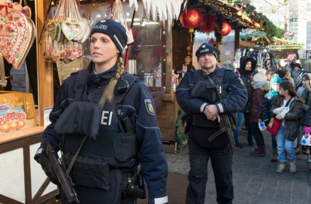 Policemen patrol over a Christmas market in Dortmund, western Germany, on December 20, 2016, as security measures are taken after a deadly rampage by a lorry driver at a Berlin Christmas market. German Chancellor Angela Merkel said that authorities believe the rampage, killing 12, was a "terrorist" attack likely committed by an asylum seeker. / AFP PHOTO / dpa / Bernd Thissen / Germany OUT