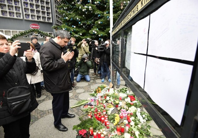 Raed Saleh, Chairman of the SPD (Social Democrats) group in the Berlin House of representatives, pays tribute in front at the Kaiser-Wilhelm-Gedaechtniskirche (Kaiser Wilhelm Memorial Church), the day after an attack at the nearby Christmas market in central Berlin, on December 20, 2016. German police said they were treating as "a probable terrorist attack" the killing of 12 people when the speeding lorry cut a bloody swath through the packed Berlin Christmas market. / AFP PHOTO / Tobias SCHWARZ