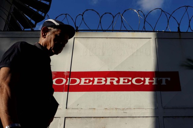 A man walks past the corporate logo of Odebrecht in a construction site in Caracas, Venezuela January 26, 2017. REUTERS/Carlos Garcia Rawlins