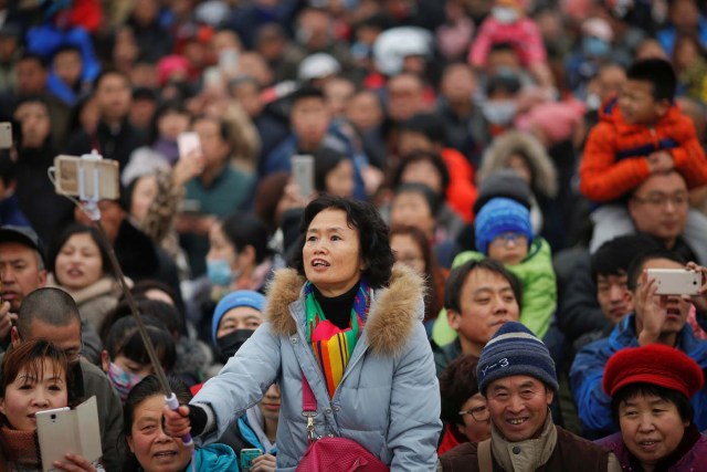 People follow performers during a re-enactment of an ancient Qing Dynasty ceremony as the Lunar New Year of the Rooster is celebrated at the temple fair at Ditan Park (the Temple of Earth), in Beijing, China January 28, 2017. REUTERS/Damir Sagolj