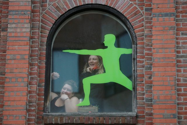 Fans in a yoga studio watch the New England Patriots victory parade through the streets of Boston after winning Super Bowl LI, in Boston