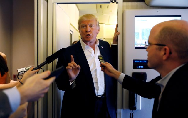 U.S. President Donald Trump speaks with reporters aboard Air Force One on his way to a "Make America Great Again" rally at Orlando Melbourne International Airport in Melbourne, Florida, U.S. February 18, 2017.  REUTERS/Kevin Lamarque