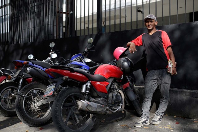Denny Benitez looks after motorbikes at Plaza Brion square, in Caracas, Venezuela February 23, 2017. Picture taken February 23, 2017. REUTERS/Marco Bello
