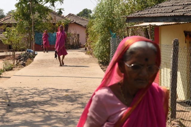 This photo taken on March 1, 2017 shows women arriving for class at Aajibaichi Shala, or "school for grannies" in the local Marathi language, in Phangane village in Maharashtra state's Thane district, some 125km northeast of Mumbai. They wear uniforms, carry satchels, and eagerly recite the alphabet in class, but the students here are different -- this is a "school for grannies". Deprived of an education as children, the women -- most of whom are widows and aged between 60 and 90 -- are finally fulfilling a life-long dream to become literate through this unique initiative near Mumbai. / AFP PHOTO / Indranil MUKHERJEE / TO GO WITH "India-education-women-school,FEATURE" by Peter HUTCHISON