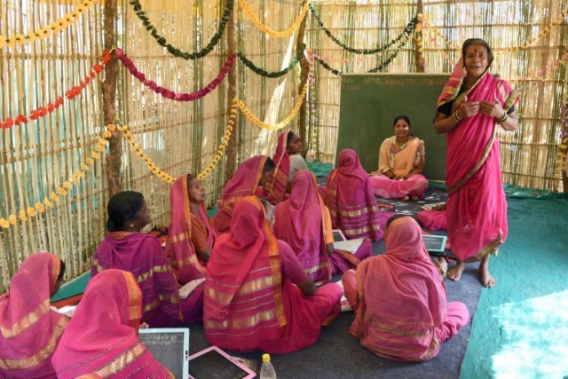 This photo taken on March 1, 2017 shows Indian grandmother, Gulab Kedar, 62, introducing herself to her classmates as they wait for the start of a class at Aajibaichi Shala, or "school for grannies" in the local Marathi language, in Phangane village in Maharashtra state's Thane district, some 125km northeast of Mumbai. They wear uniforms, carry satchels, and eagerly recite the alphabet in class, but the students here are different -- this is a "school for grannies". Deprived of an education as children, the women -- most of whom are widows and aged between 60 and 90 -- are finally fulfilling a life-long dream to become literate through this unique initiative near Mumbai. / AFP PHOTO / Indranil MUKHERJEE / TO GO WITH "India-education-women-school,FEATURE" by Peter HUTCHISON
