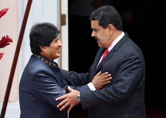 Venezuela's President Nicolas Maduro (R) speaks to Bolivia's President Evo Morales during the welcoming ceremony of an ALBA alliance summit to mark fourth anniversary of the death of Venezuela's late President Hugo Chavez in Caracas, Venezuela, March 5, 2017. REUTERS/Carlos Garcia Rawlins