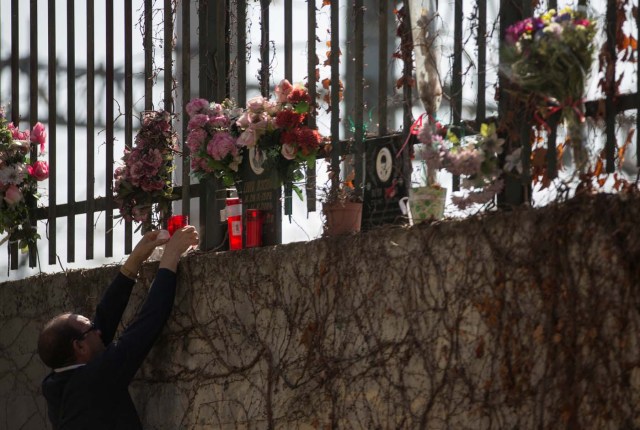 A man places candles at the same spot a train was bombed in the 2004 Madrid train bombings, at a memorial site for the victims of the bombings, near Atocha station in Madrid, Spain, March 11, 2017. REUTERS/Sergio Perez