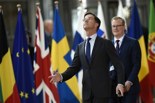 Dutch Prime Minister and leader of the People's Party for Freedom and Democracy (Volkspartij voor Vrijheid en Democratie - VVD) Mark Rutte (1st-L) arrives to attend the EU summit at the new "Europa" building in Brussels on March 9, 2017. / AFP PHOTO / JOHN THYS