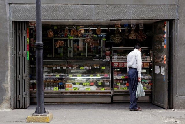 A man looks at prices in a grocery store in downtown Caracas, Venezuela March 10, 2017. REUTERS/Marco Bello