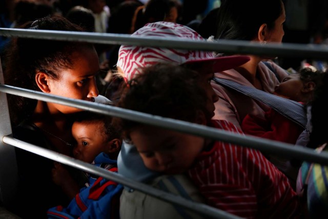 Women carrying babies queue on the street as they try to buy diapers outside a pharmacy in Caracas, Venezuela March 18, 2017. REUTERS/Carlos Garcia Rawlins SEARCH "GARCIA QUEUEING" FOR THIS STORY. SEARCH "WIDER IMAGE" FOR ALL STORIES.