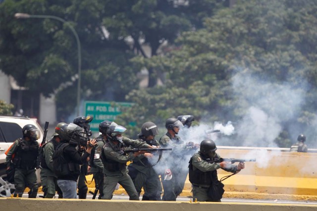 Riot police fire tear gas as demonstrators rally against Venezuela's President Nicolas Maduro's government in Caracas, Venezuela April 10, 2017. REUTERS/Christian Veron
