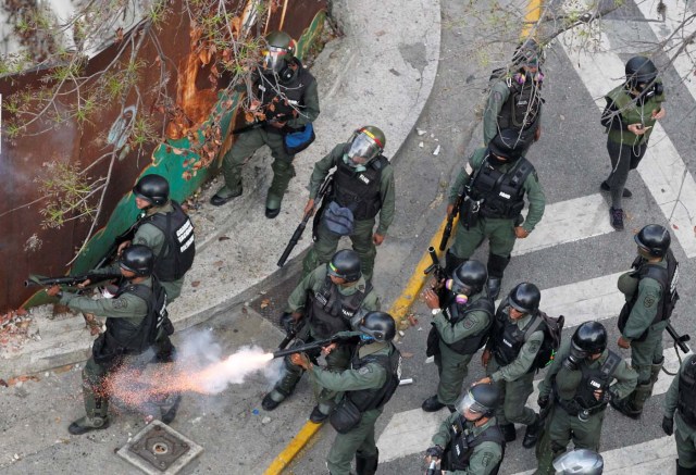 Riot police fire tear gas during a rally against Venezuela's President Nicolas Maduro's government in Caracas, Venezuela April 10, 2017. REUTERS/Christian Veron