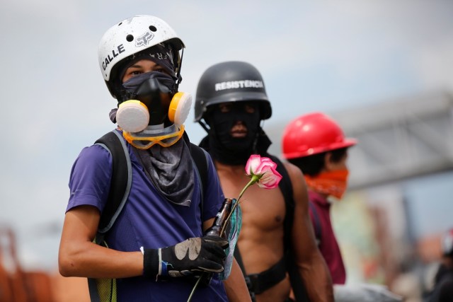 A demonstrator holds a flower during a protest against Venezuela's President Nicolas Maduro's government in Caracas, Venezuela, May 13, 2017. REUTERS/Carlos Garcia Rawlins TPX IMAGES OF THE DAY