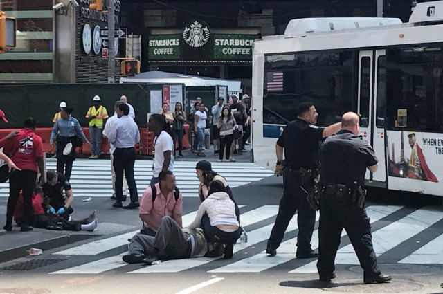 First responders are at the scene as people help injured pedestrians after a vehicle struck pedestrians on a sidewalk in Times Square in New York, U.S., May 18, 2017. REUTERS/Jeremy Schultz