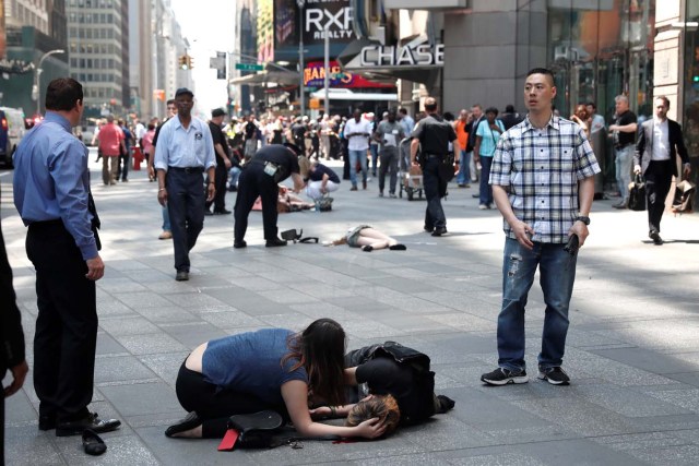 ATTENTION EDITORS - VISUALS COVERAGE OF SCENES OF INJURY Injured people are seen on the sidewalk in Times Square after a speeding vehicle struck pedestrians on the sidewalk in New York City, U.S., May 18, 2017. REUTERS/Mike Segar