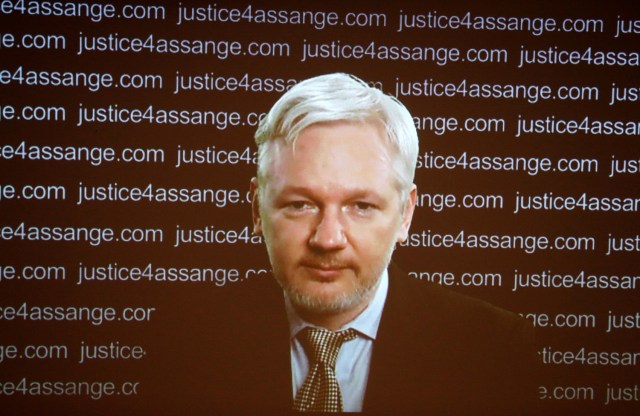 FILE PHOTO: WikiLeaks founder Julian Assange appears on screen via video link during a news conference at the Frontline Club in London, Britain February 5, 2016. Assange should be allowed to go free from the Ecuadorian embassy in London and be awarded compensation for what amounts to a three-and-a-half-year arbitrary detention, a U.N. panel ruled on Friday. REUTERS/Neil Hall/File Photo
