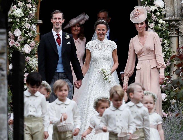 Pippa Middleton and James Matthews smile as they are joined by Britain's Catherine, Duchess of Cambridge after their wedding at St Mark's Church in Englefield, Britain on May 20, 2017. REUTERS/Kirsty Wigglesworth/Pool