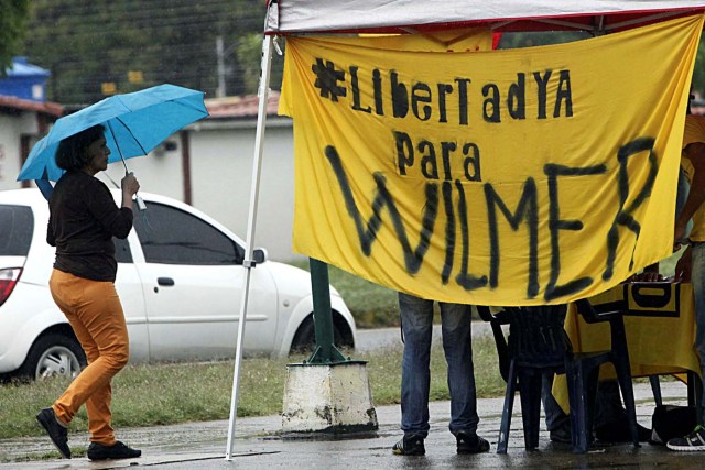 A woman walks past a banner that reads, "Freedom for Wilmer" in Barinas, Venezuela June 12, 2017. Picture taken June 12, 2017. REUTERS/Carlos Eduardo Ramirez