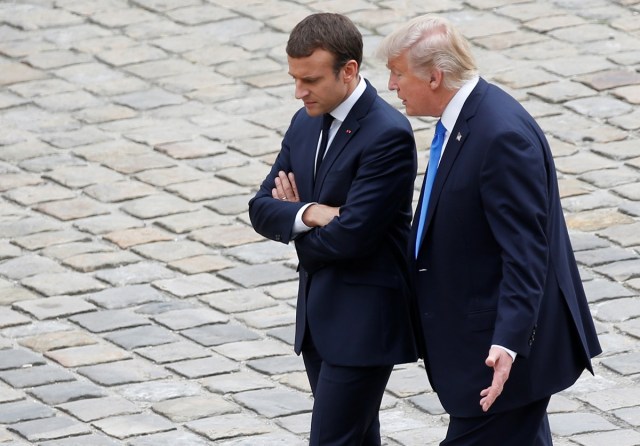 French President Emmanuel Macron and U.S. President Donald Trump walk in the courtyard as they leave after a welcoming ceremony at the Invalides in Paris, France, July 13, 2017. REUTERS/Charles Platiau     TPX IMAGES OF THE DAY