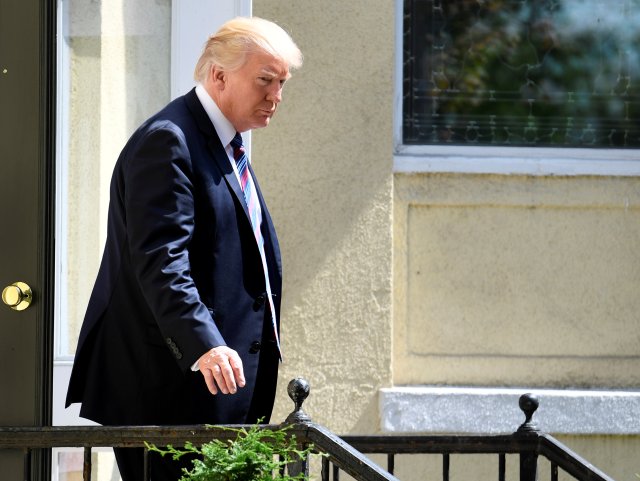 President Donald Trump departs St. John's Episcopal Church ahead of First Lady Melania Trump after they attended services for a national "Day of Prayer", for victims of the Hurricane Harvey flooding in Texas, in Washington, U.S., September 3, 2017. REUTERS/Mike Theiler