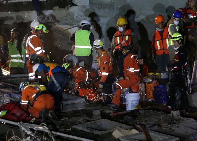 Members of rescue teams search for survivors in the rubble of a collapsed building after an earthquake in Mexico City, Mexico September 23, 2017. REUTERS/Henry Romero