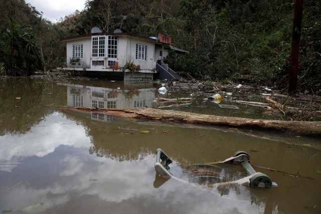 A house submerged by flood waters is seen close to the dam of the Guajataca lake after the area was hit by Hurricane Maria in Guajataca, Puerto Rico September 23, 2017. REUTERS/Carlos Garcia Rawlins