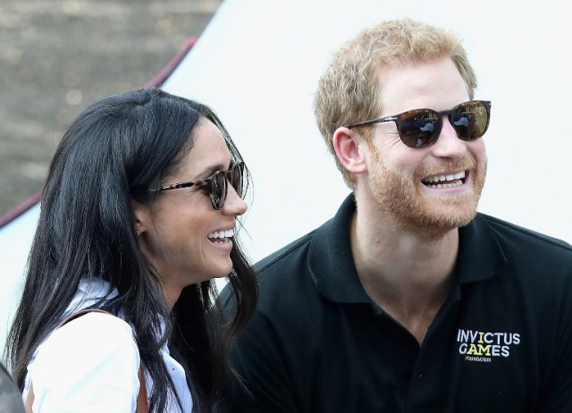 TORONTO, ON - SEPTEMBER 25: Prince Harry (R) and Meghan Markle (L) attend a Wheelchair Tennis match during the Invictus Games 2017 at Nathan Philips Square on September 25, 2017 in Toronto, Canada Chris Jackson/Getty Images for the Invictus Games Foundation /AFP