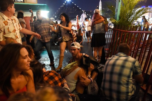 LAS VEGAS, NV - OCTOBER 01: People run for cover at the Route 91 Harvest country music festival after apparent gun fire was heard on October 1, 2017 in Las Vegas, Nevada. There are reports of an active shooter around the Mandalay Bay Resort and Casino.   David Becker/Getty Images/AFP