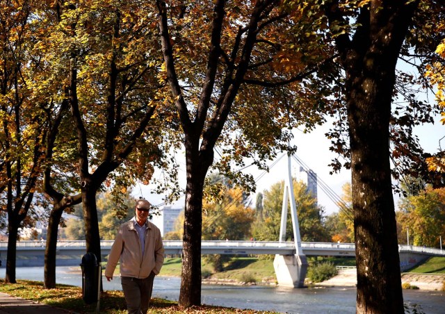 A man walks on a warm autumn day in the central town park in Zenica, Bosnia and Herzegovina, October 13, 2017. REUTERS/Dado Ruvic