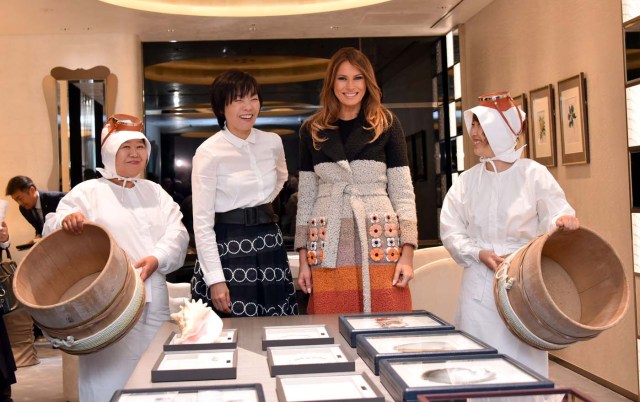 U. S. first lady Melania Trump poses with Japan's first lady Akie Abe, alongside Ama divers, during their visit to the Mikimoto Pearl head shop in Tokyo's Ginza district, Japan, November 5, 2017. REUTERS/Katsumi Kasahara/Pool
