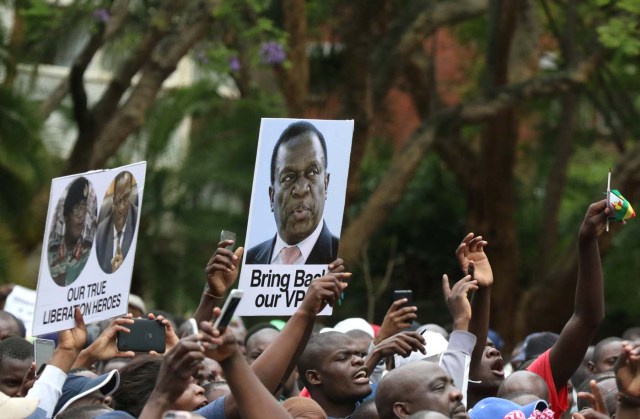 Protesters hold posters showing support for ousted Zimbabwean vice-President Emmerson Mnangagwa, in Harare, Zimbabwe, November 18, 2017. REUTERS/Philimon Bulawayo NO RESALES. NO ARCHIVES