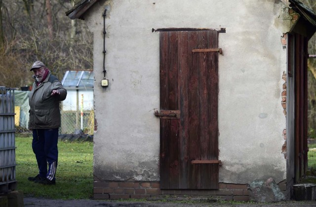 Resident Paul Urbanek is pictured in Alwine, a splinter settlement of the town Uebigau-Wahrenbrueck, eastern Germany, on November 30, 2017. On Saturday, Alwine's dozen buildings, plus sheds and garages, are to go under the hammer at an auction in Berlin, with a starting price of 125,000 euros ($148,000). / AFP PHOTO / Tobias Schwarz