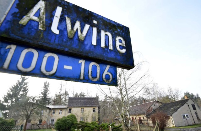 A street sign of Alwine, a splinter settlement of the town Uebigau-Wahrenbrueck, eastern Germany, is pictured on November 30, 2017. On Saturday, Alwine's dozen buildings, plus sheds and garages, are to go under the hammer at an auction in Berlin, with a starting price of 125,000 euros ($148,000). / AFP PHOTO / Tobias Schwarz