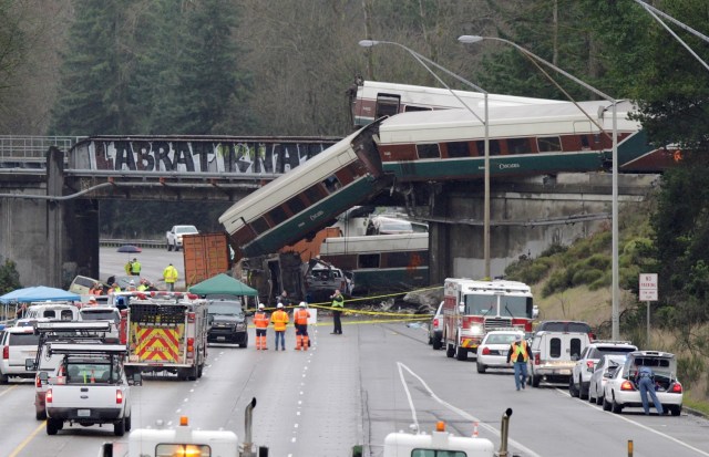 Rescue personnel and equipment are seen at the scene where an Amtrak passenger train derailed on a bridge over interstate highway I-5 in DuPont, Washington, U.S. December 18, 2017. REUTERS/Steve Dipaola