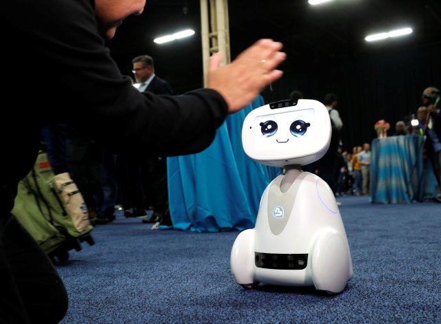 Buddy, an entertainment and assistant robot by Blue Frog Robotics, interacts with a attendee during CES Unveiled at the 2018 CES in Las Vegas, Nevada, U.S. January 7, 2018. REUTERS/Steve Marcus
