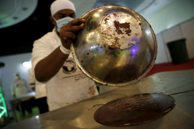 Imagen de archivo. Un artesano, vierte chocolate para hacer monedas en Caracas, Venezuela el 1 de octubre de 2015. REUTERS/Carlos Garcia Rawlins