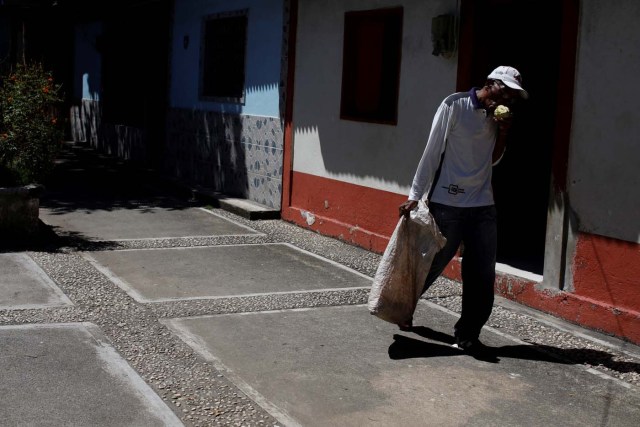 Yoffre Echarri eats from a cocoa pod as he walks close to his house in Caruao, Venezuela October 24, 2017. Picture taken October 24, 2017. REUTERS/Carlos Garcia Rawlins