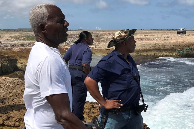 Police officers look for belongings and evidences at the shore where bodies of four people were found, near Willemstad, Curacao January 11, 2018. REUTERS/Umpi Welvaart