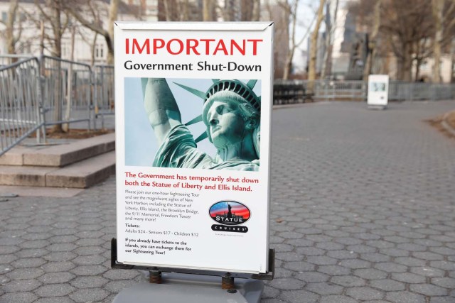 A sign announcing the closure of the Statue of Liberty, due to the U.S. government shutdown, sits near the ferry dock to the Statue of Liberty at Battery Park in Manhattan, New York, U.S. January 21, 2018. REUTERS/Shannon Stapleton